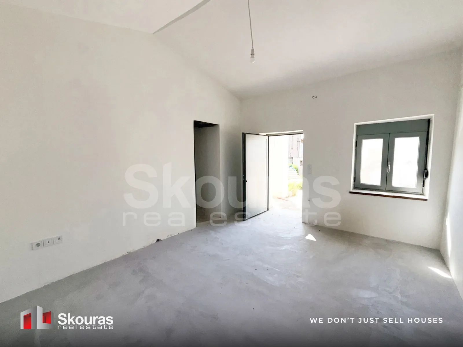 Interior room with a door opening to the garden, Ammos house