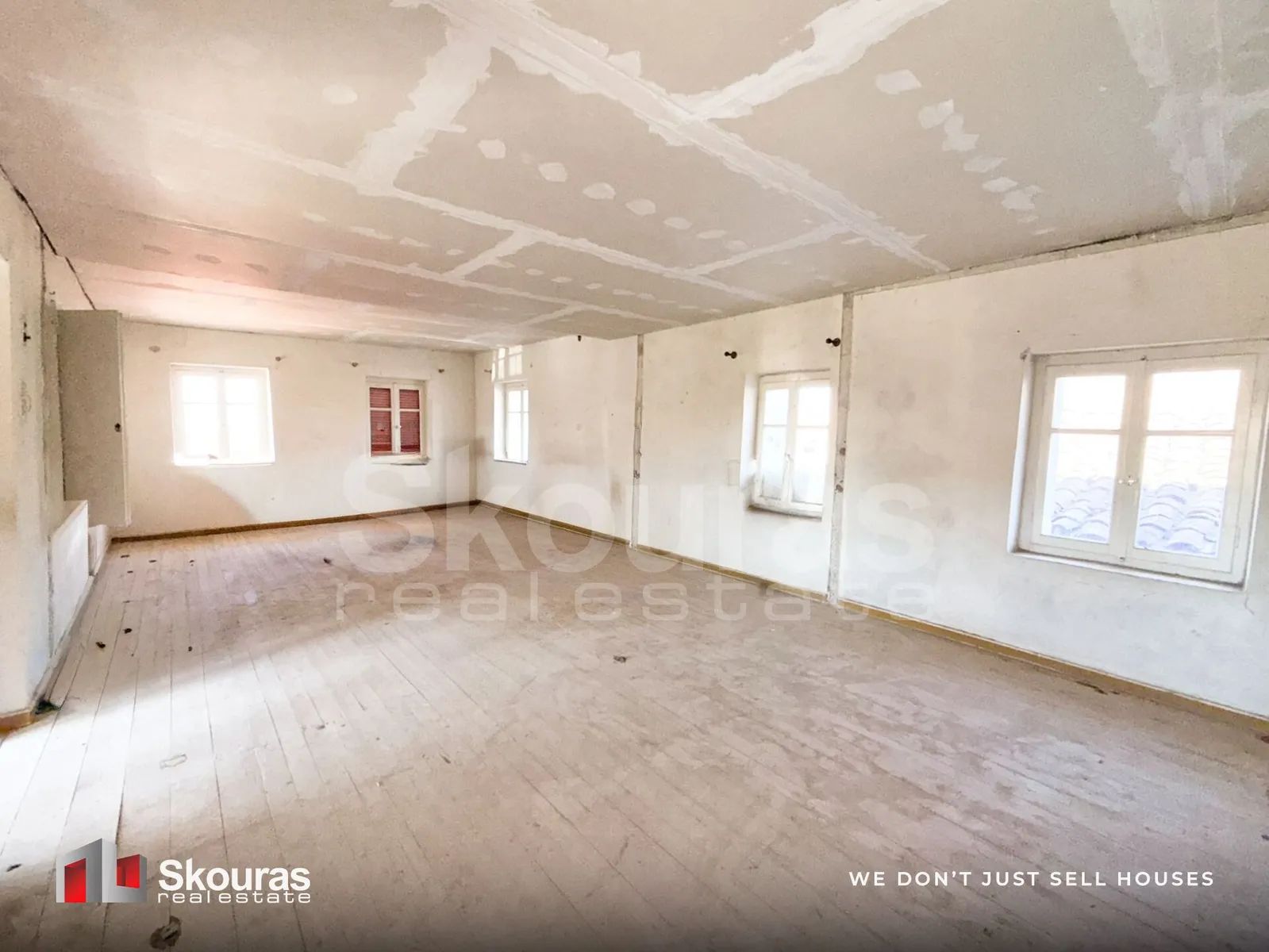 Bright upper-floor room with French doors in the Ammos house, Messinia