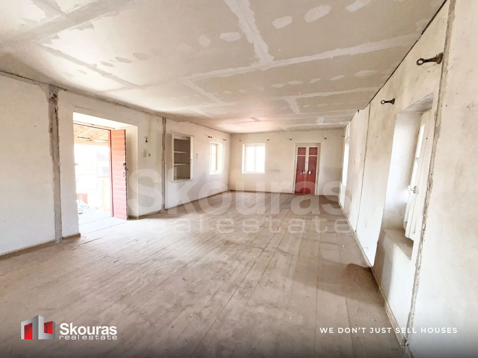 Spacious upper-floor room with original wooden floorboards